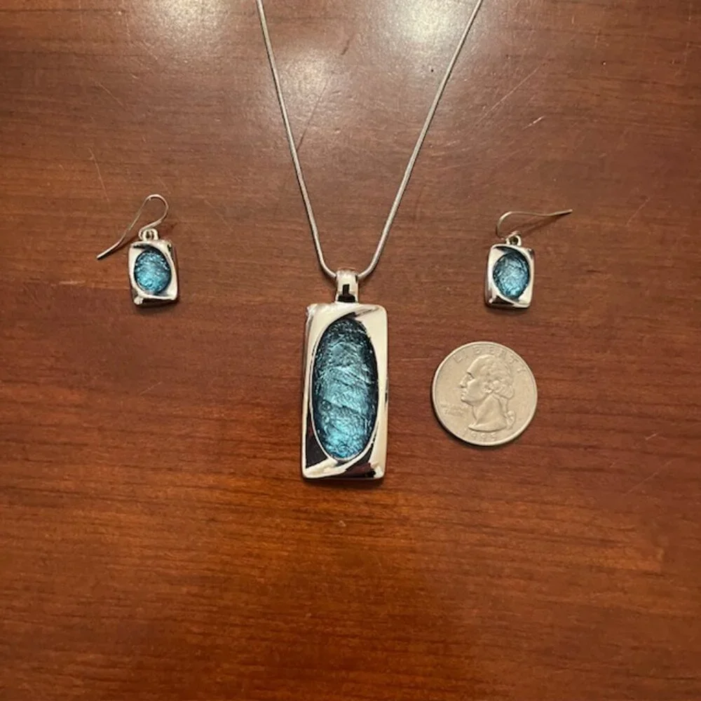 Aqua blue glass pendant and silver tone chain with matching earrings